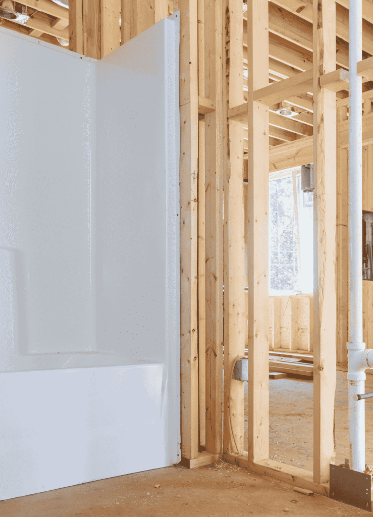 Bathroom renovation framing with newly installed tub and exposed stud walls, showing Alcord Construction’s precise workmanship during a home remodeling project in Middle Georgia.