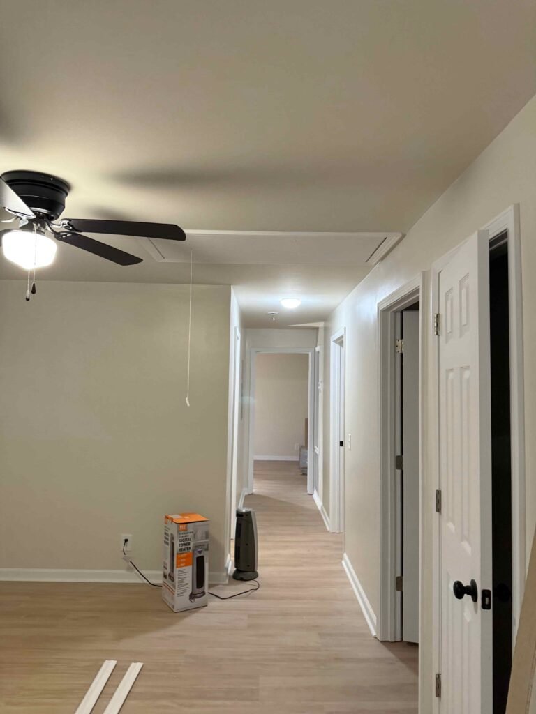Newly renovated hallway with fresh paint, updated flooring, modern lighting, and clean trim work, showcasing Alcord Construction’s polished interior remodeling craftsmanship in Middle Georgia.